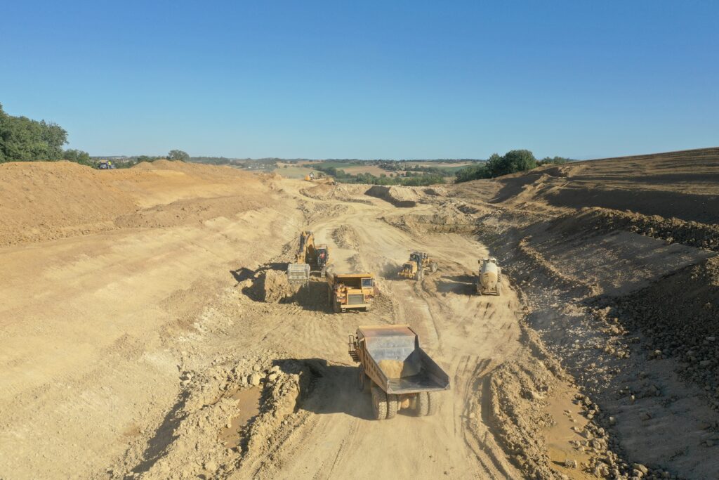 excavator_and_dump_trucks_working_on_Jobsite_Gimont